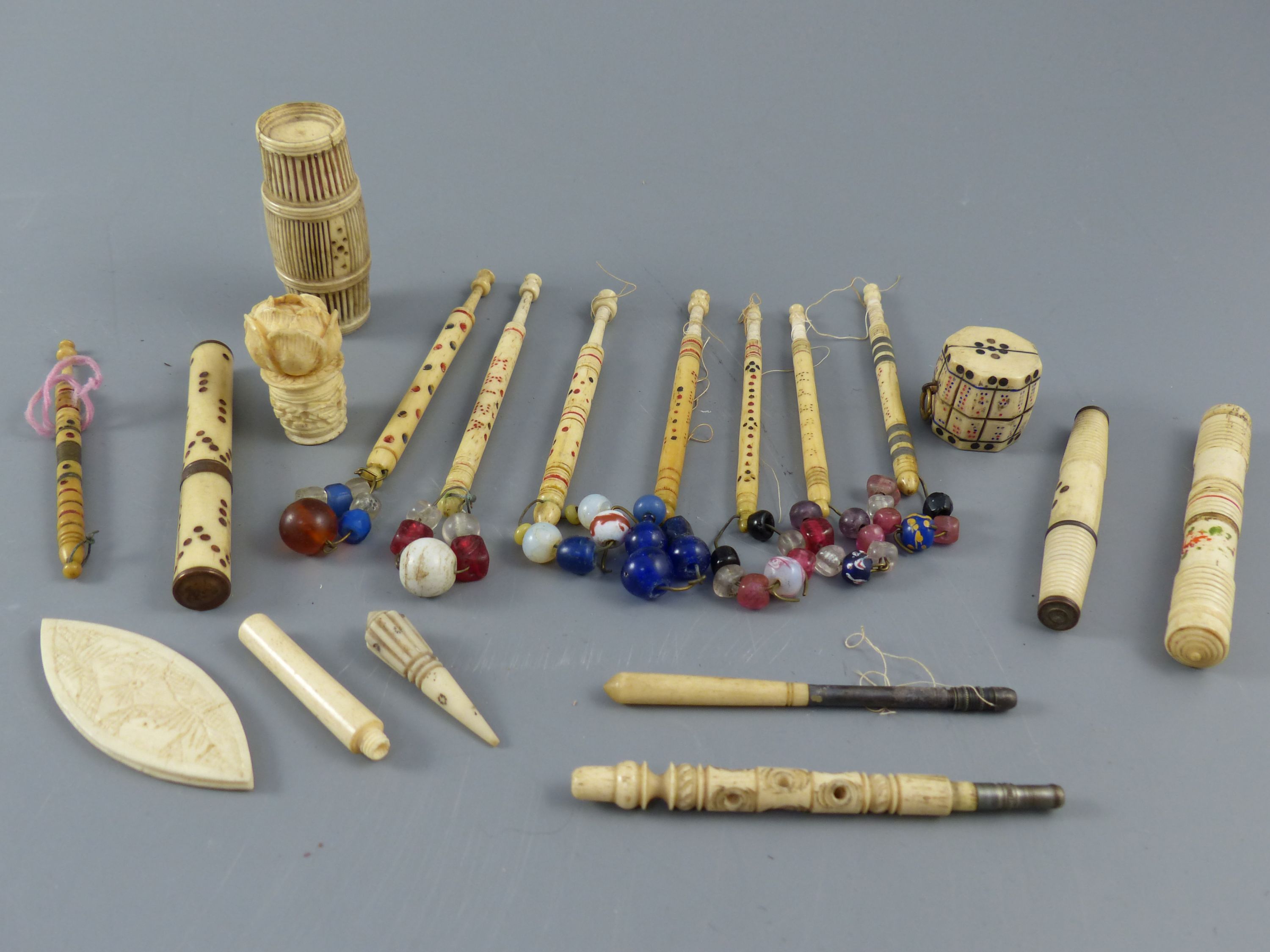 A collection of assorted 19th century stained ivory and bone sewing implements